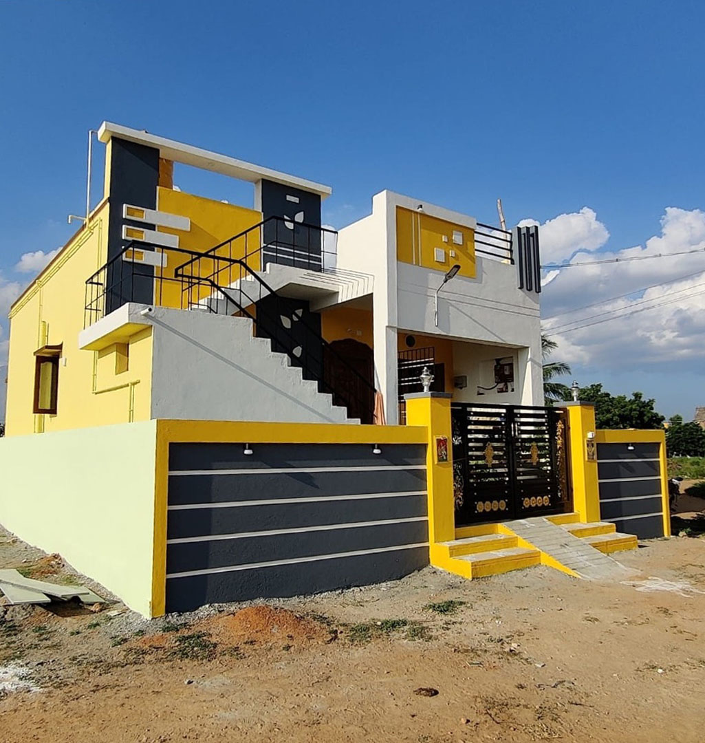 Completed two-storey VK Builders house with yellow and charcoal facade and black exterior staircase, Avadi, Chennai