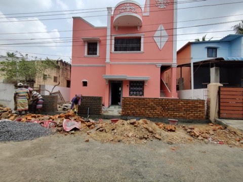 Workers laying a brick boundary compound wall, VK Builders project