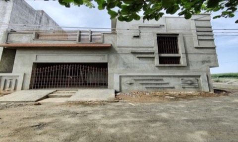 Bare concrete house structure with window grilles, mid-construction, VK Builders site
