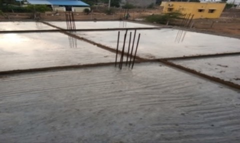 Freshly poured concrete foundation slab with rebar starter bars, VK Builders site