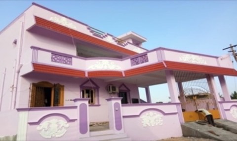 Completed pink and purple two-storey house with decorative pillars and gate, VK Builders project