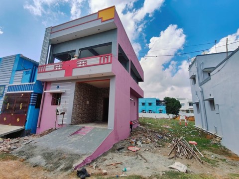 Completed pink and grey house with checkered-tile accent column, VK Builders project